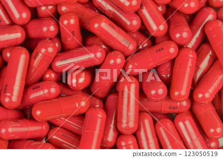 A stack of medicines in capsules. Capsule medication as background. The concept of pharmacy and drug abuse. Macro image. Close-up 123050519