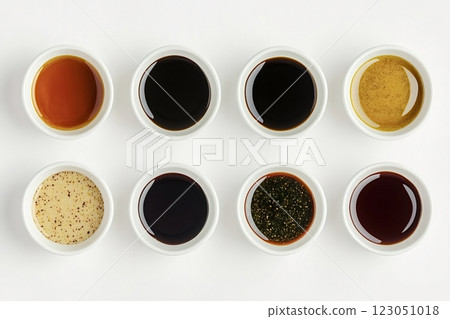 Various sauces in small white bowls on white background 123051018