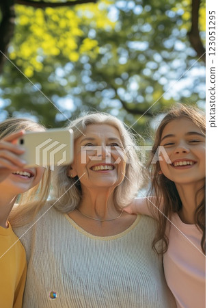 A joyful grandmother taking a selfie with children 123051295