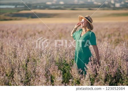 Woman Lavender Field Summer: Happy woman enjoys scenic summer lavender field, idyllic countryside, peaceful relaxation. 123052084