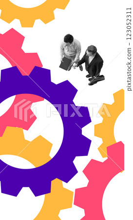 Two businessmen shaking hands while standing near large colorful gears, representing partnership, collaboration, and structured workflow Two businessmen shaking hands while standing near large colorful gears, representing partnership, collaboration, and structured workflow 123052311