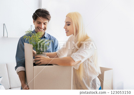 New Home. Happy Spouses Packing Things In Moving Boxes Preparing For Relocation. Empty Space For Text 123053150