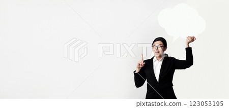 A businesswoman with glasses holds a blank thought bubble and points her finger up as if she has an idea. 123053195