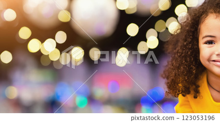 Pure beauty. Portrait of adorable little african girl, christmas lights on background 123053196