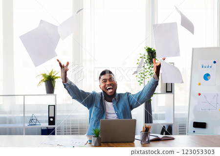 Business success concept. Happy African American Businessman Throwing Papers In The Air In Office, Celebrating Completing Project. 123053303