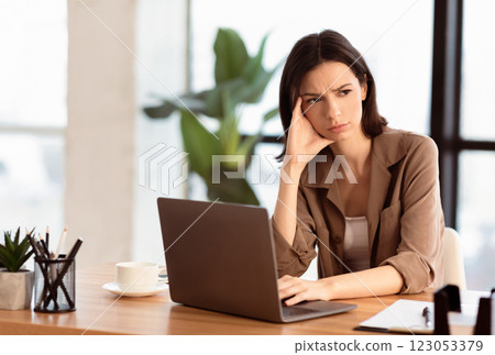What To Do. Puzzled confused woman thinking hard concerned about problem solution looking aside, using laptop, copyspace What To Do. Puzzled confused woman thinking hard concerned about problem solution looking aside, using laptop, copyspace 123053379