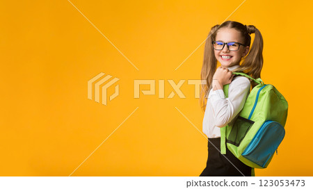 Schoolgirl Posing With School Backpack Smiling To Camera Standing Over Yellow Background. Studio Shot 123053473
