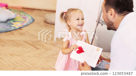 Love You. Daughter congratulating dad and giving him postcard with Happy father's day text, free space Love You. Daughter congratulating dad and giving him postcard with Happy father's day text, free space 123053487