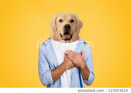 A person stands smiling with their arms crossed over their chest, featuring a golden retriever's head superimposed on their body. The solid yellow background emphasizes the playful and humorous nature 123053624