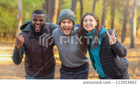 Emotional international group of tourists posing over autumn forest background 123053662
