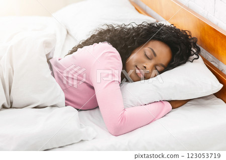Cozy bedtime. Young pretty african woman sleeping in bed, panorama Cozy bedtime. Young pretty african woman sleeping in bed, panorama 123053719
