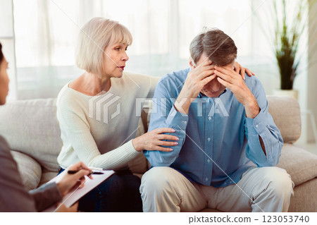 Loving Mature Wife Supporting Her Depressed Husband During Psychotherapy Session With Counselor, Free Space 123053740