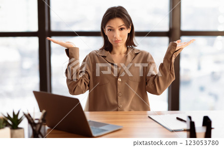 I Have No Idea. Confused young woman shrugging her shoulders with spreaded hands, free space I Have No Idea. Confused young woman shrugging her shoulders with spreaded hands, free space 123053780