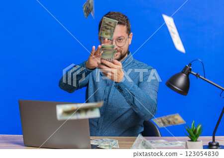 Man wasting throwing sharing money dollar cash around, big profit, winning lottery casino jackpot 123054830
