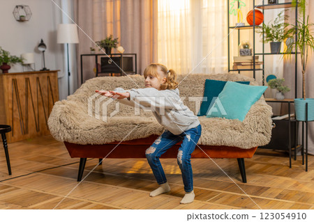 Young teenager girl kid doing easy squat exercise at home, counting out loud, flop with smile finish Young teenager girl kid doing easy squat exercise at home, counting out loud, flop with smile finish 123054910