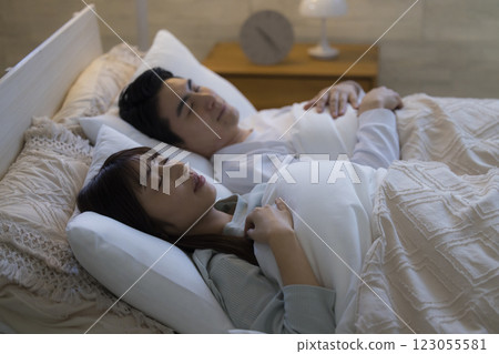A couple sleeping in bed A couple sleeping in bed 123055581
