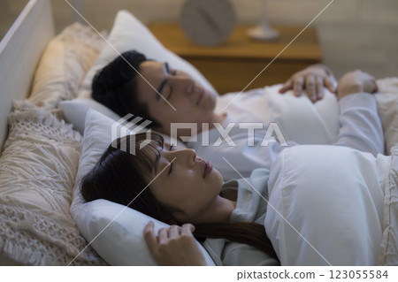 A couple sleeping in bed A couple sleeping in bed 123055584