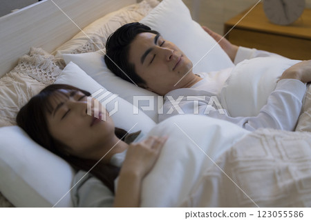 A couple sleeping in bed A couple sleeping in bed 123055586