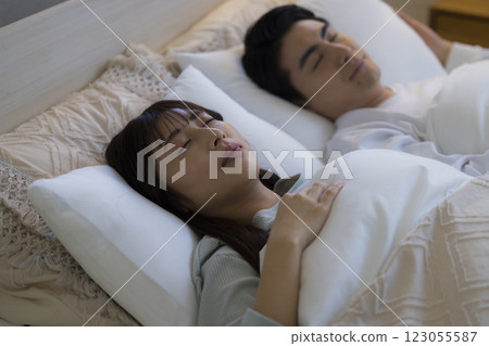 A couple sleeping in bed 123055587