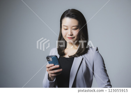 A woman watching a smartphone A woman watching a smartphone 123055915