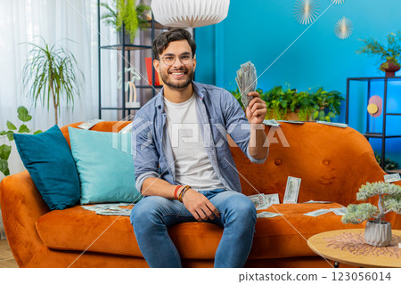 Successful happy rich business man counting money cheering up with high profits, lottery game win 123056014