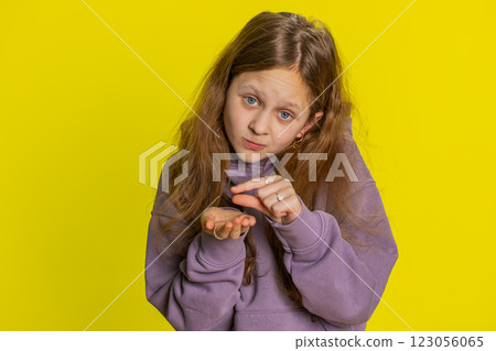 Child girl show a little bit gesture begging help need some more please give me measuring small size 123056065