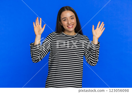 Happy woman smiling friendly waving hands gesturing hello greeting or goodbye, meeting invitation Happy woman smiling friendly waving hands gesturing hello greeting or goodbye, meeting invitation 123056098