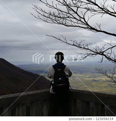 Climber looking at the view from the summit 123056214