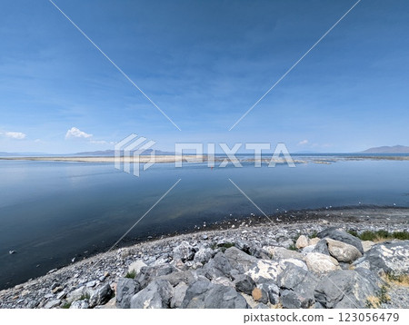 Scenic View of the Great Salt Lake with Rocky Shoreline and Clear Blue Sky. 123056479