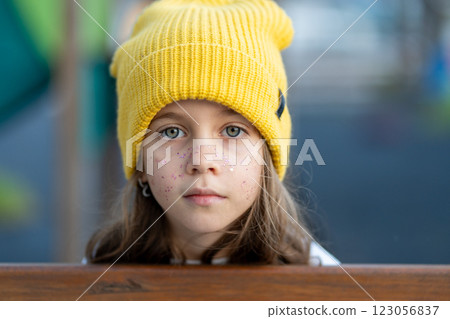 Closeup portrait of serious girl in yellow cap 123056837