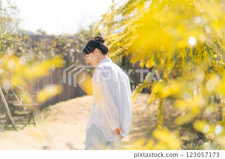 A young woman walking in the garden A young woman walking in the garden 123057173
