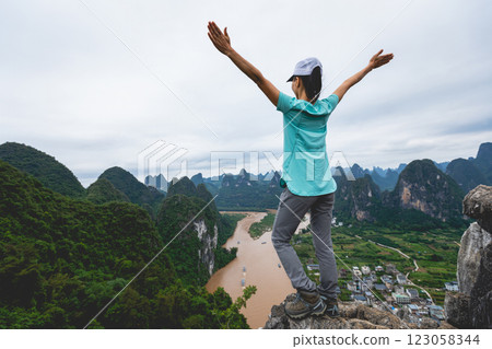 Woman tourist enjoy the beautiful landscape of yangshuo county, China Woman tourist enjoy the beautiful landscape of yangshuo county, China 123058344