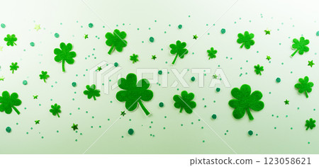 Happy St Patrick's Day decoration concept made from shamrocks ( clover leaf) on green pastel background. 123058621