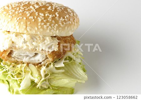 Tartar fish burger photographed on a white background (showing the inside) 123058662