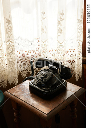 A black Showa-era telephone placed by the window A black Showa-era telephone placed by the window 123059365