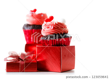 Chocolate cupcakes with pink cream and heart shaped sprinkles. 123059641