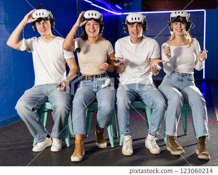 Stunned by exciting game, group of friends lowered helmet and took break from game. 123060214