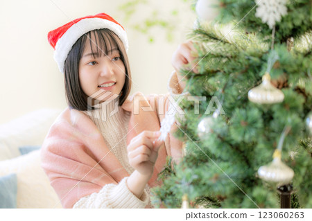 Girls decorating Christmas trees Girls decorating Christmas trees 123060263