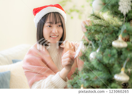 Girls decorating Christmas trees Girls decorating Christmas trees 123060265