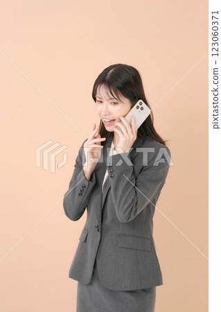 有一套衣服的一名婦女與智能手機 有一套衣服的一名婦女與智能手機 123060371