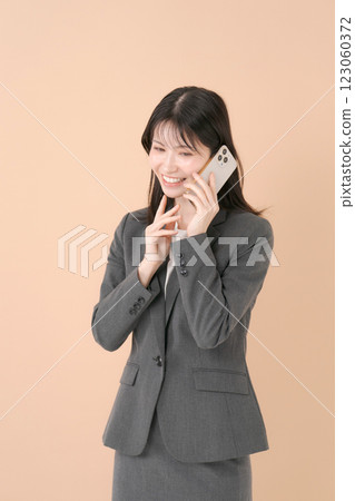 A woman with a suit with a smartphone 123060372