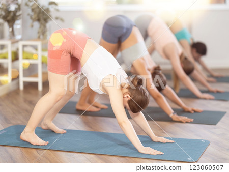 Women meditates in yoga pose parshvottanasana in gym 123060507