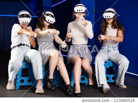 Girls using virtual reality glasses - girlfriends having fun with vr headset Girls using virtual reality glasses - girlfriends having fun with vr headset 123060524