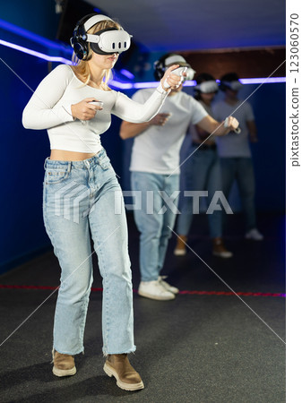 Girl learning dance movement in VR helmet 123060570