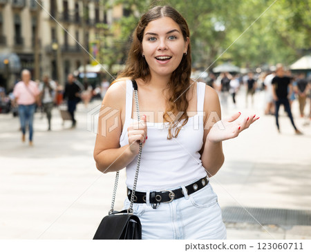 Happy young woman posing cheerfully in Rambla Street of Barcelona 123060711