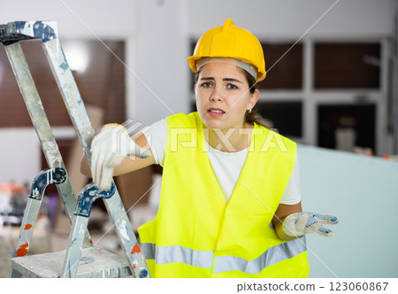Puzzled confused female civil engineer inside building under construction Puzzled confused female civil engineer inside building under construction 123060867