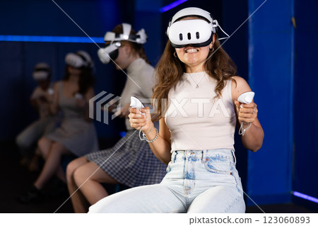 Girls using virtual reality glasses - girlfriends having fun with vr headset 123060893