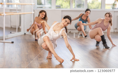 Young woman performing sass dance during group class 123060977