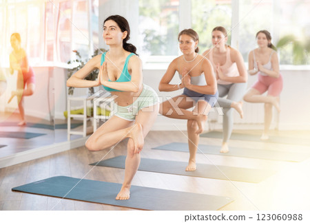 Fitness, sport and healthy lifestyle concept: woman doing yoga yoga pose - vrikshasana pose 123060988