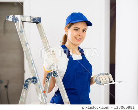 Portrait of builder in process of finishing work 123060991